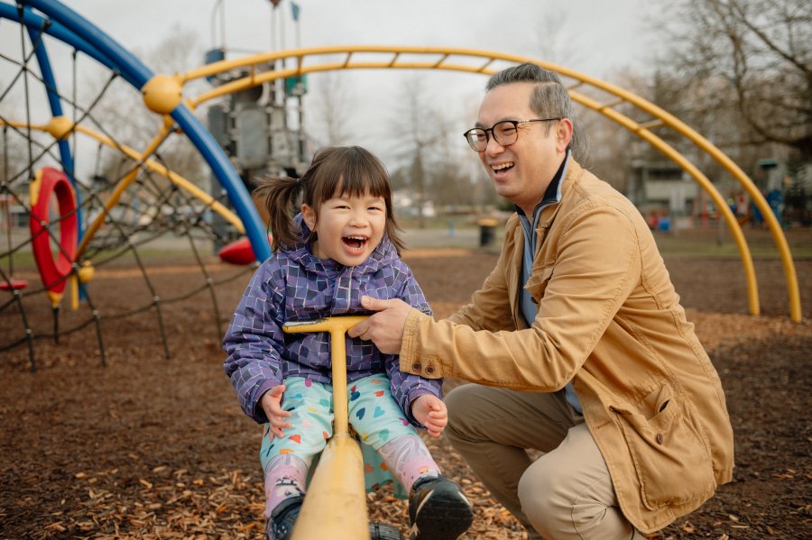 dad and daughter at bear creek surrey park with family at the playground